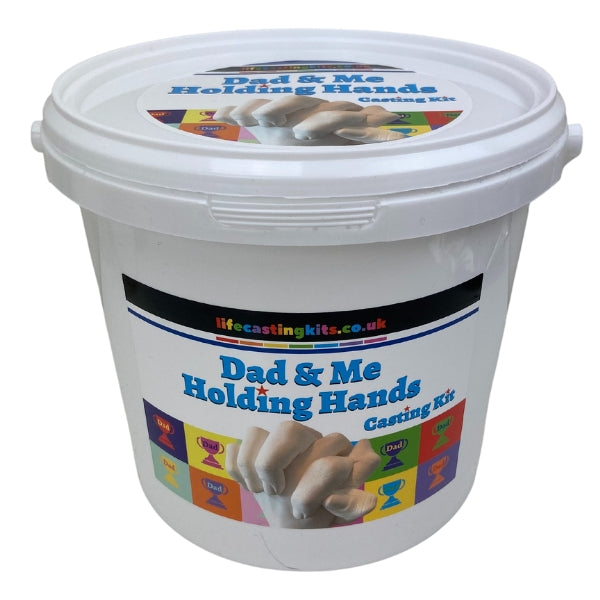 A holding hands life casting kit in a bucket style with a multicoloured label design with different checked squares featuring a trophy and the word Dad on it and the logo lifecastingkits.co.uk at the top and Dad & Me holding hands casting kit underneath