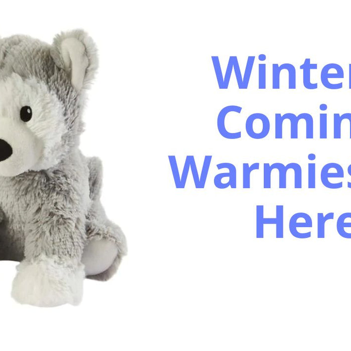 Image of a Warmies soft cuddly husky dog. The dog is grey and white, super cute and soft and cuddly. Next to the husky are the words 'Winter Is Coming' and 'Warmies are here!' 