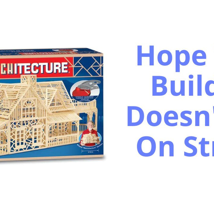 image shows a box with a large country house made of matchsticks on the front and the logo matchitecture above the house. it shows a match stick country house building kit