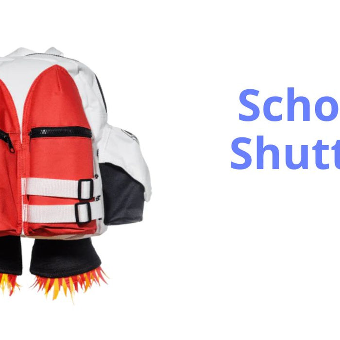 Image of a child's jetpack backpack, designed to look like a pair of red rockets with flames coming out the end and the word fuel written on the left hand red rocket. The main body of the bag is white with black trim.