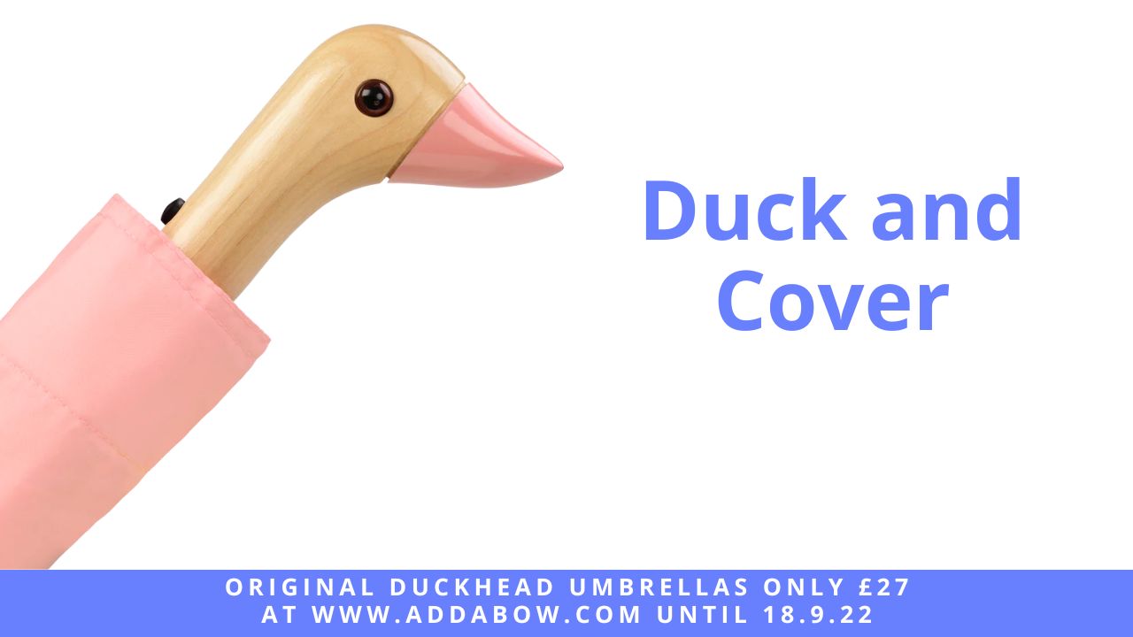 image of an umbrella whose handle is shaped like a friendly duck head, the umbrella is pink. next to the original duckhead umbrella are the words 'duck and cover' and below the image is test explaining that these umbrellas are only £27 at www.addabow.com