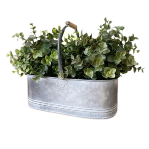 A rustic looking, decorative metal trug/planter with an overly distressed setting and complete with a wooden carry handle.   Perfect for placing in any kitchen with a Country Charm setting.  Please note handles are not fixed.  Size is approximately 30 cm.