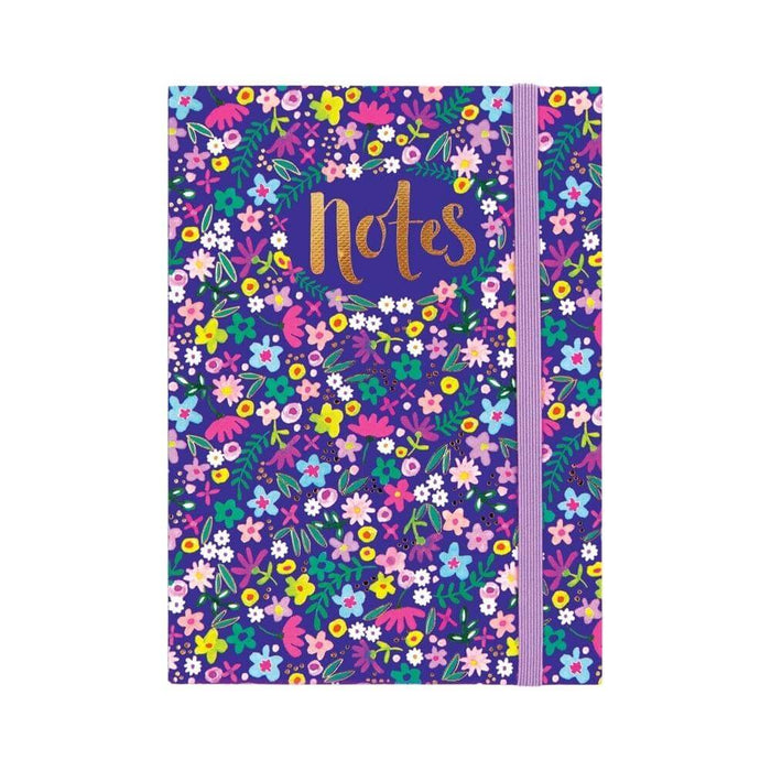 Image of a navy blue notebook with pretty floral pattern and lilac elasticated band to close the book.