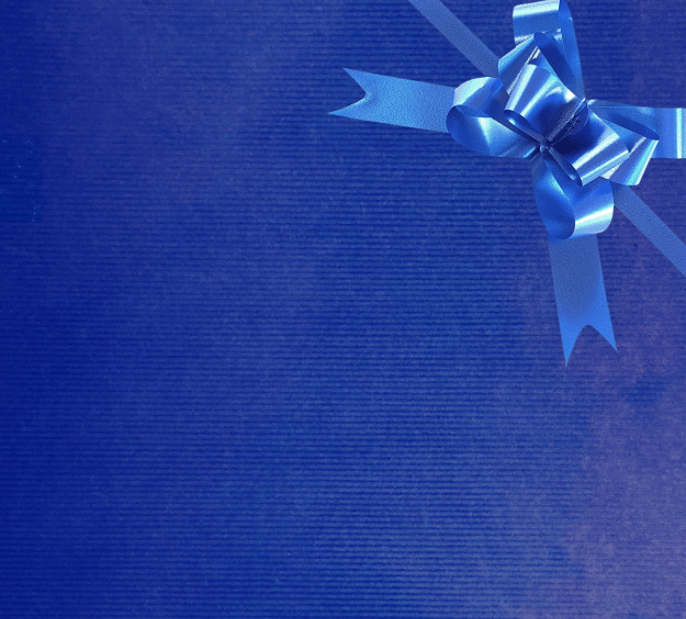 image of a square of wrapping paper, the paper is a solid dark blue kraft paper, in the corner of the gift wrap paper is a white gift wrapping bow