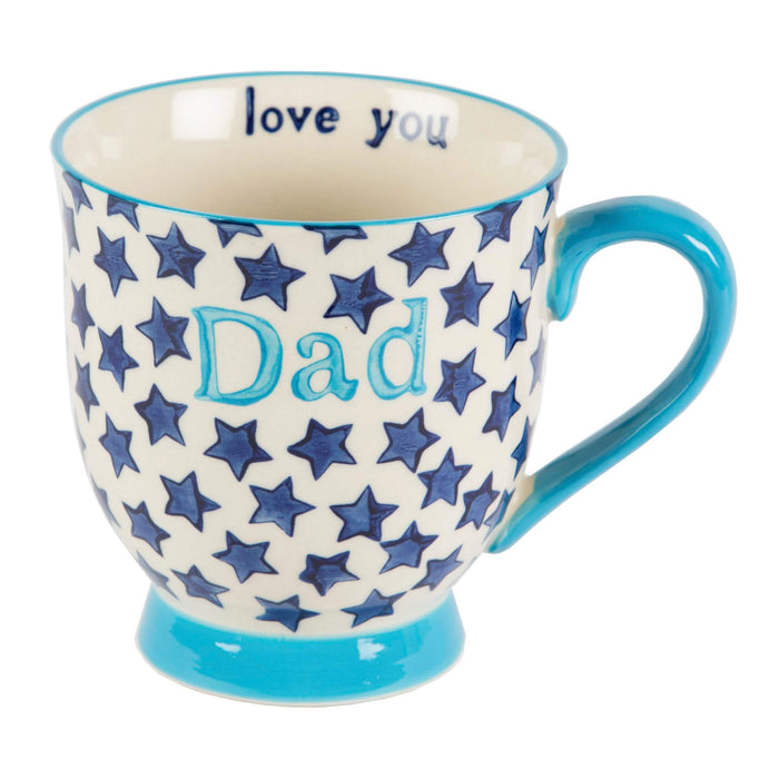 image of a mug in blue and cream with dark blue stars and featuring the word 'Dad' written on the outside and 'love you' written on the inside.