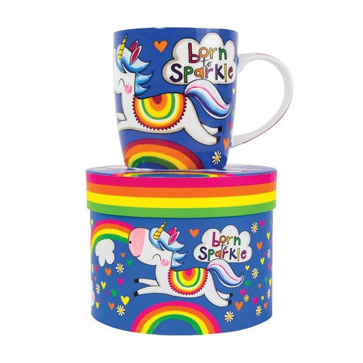 image of a royal blue mug with a friendly, happy unicorn idesign includinga  rainbow and love hearts. the mug is sat on top of a hat style gift box.