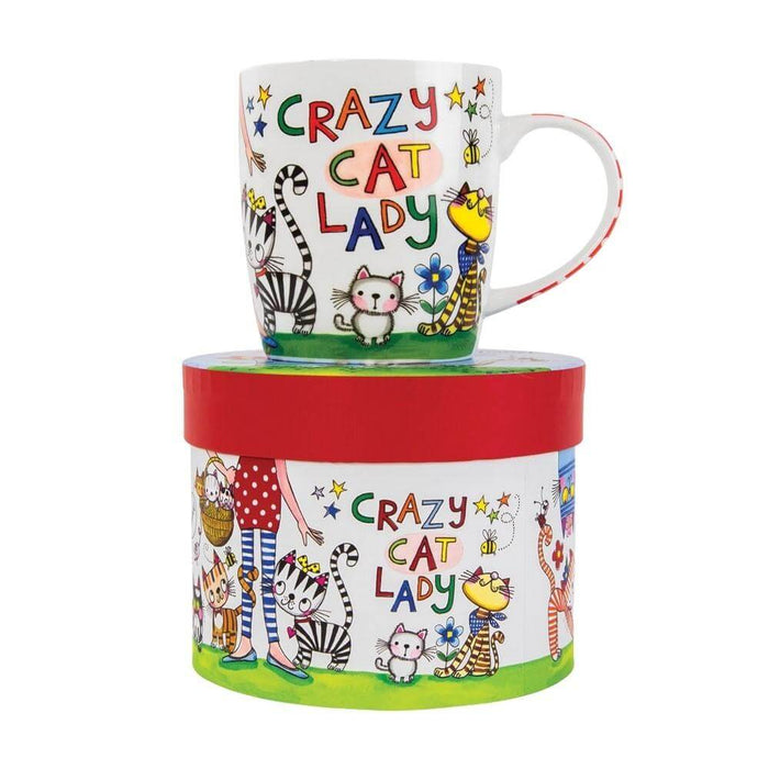 image of a white mug with cartoon cat designs including the words crazy cat lady. the mug is sat on top of a hat style gift box.