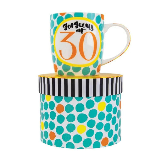 image of a predominantly white and teal coloured mug, white background with lots of teal circles and a large yellow outlined circle in the centre with text saying gorgeous at 30 in it. the mug is sat on top of a hat style gift box.