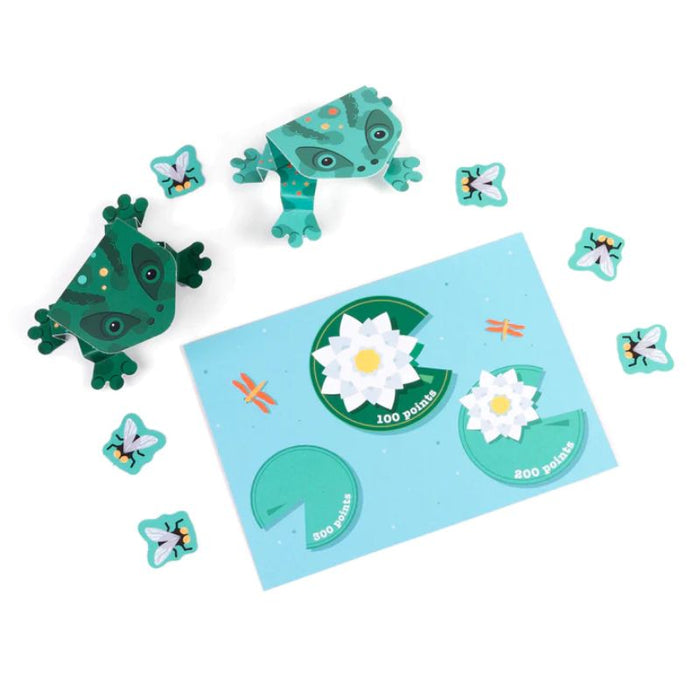 Take a leap and create your own jumping frogs! Make these frogs jump and flip all the way to the lily pads. Can you make your frog jump the highest? Who will catch the most flies and be top of the pond? No glue or scissors needed. Contents: 1 fold-out card with 7 pre-cut and scored pieces making 2 jumping frogs, 6 flies, 1 lily pad and a gameboard. Made from FSC certified recycled card. Age 5+. Letter Box Sized Gift.