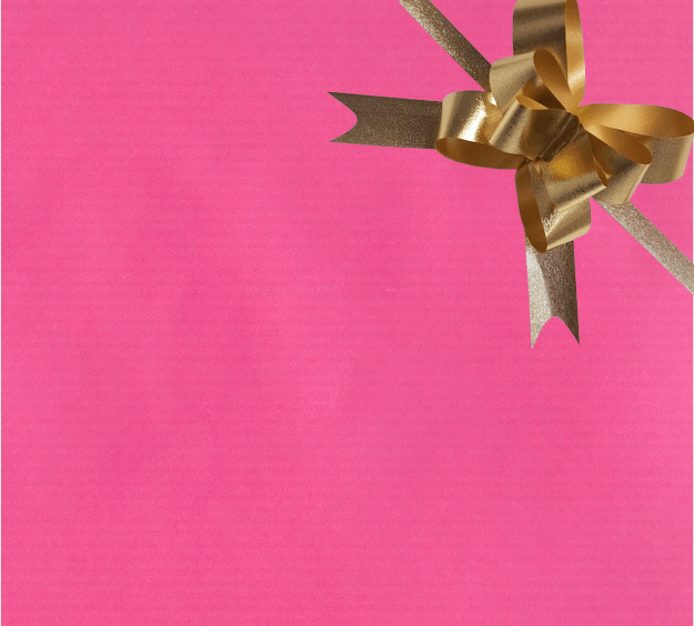 image of a square of pink wrapping paper, the paper is a solid fuchsia kraft paper, in the centre of the gift wrap paper is a red paper gift wrapping bow