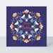image of a greetings card which has an indigo background and a symmetrial circle of pretty amber and white flowers with an smaller cirlce of pretty blue birds followed by an inner circle of pretty blue flowers. In the centre of the card are the words happy birthday to you. its a happy birthday card.