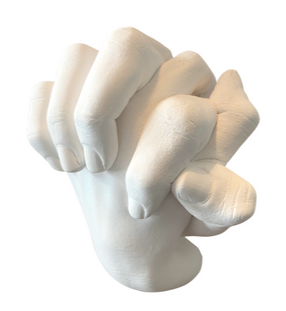 image of a pair of interwoven hands, holding hands cast in white stone
