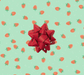 image of a square of wrapping paper, the paper has a light green almost mint background with lots of illustrated stawberries on it, in the corner of the gift wrap paper is a red gift wrapping bow