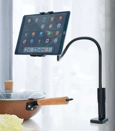 image of a black long neck tablet holder/phone holder. the tablet shows a typical tablet home screen and the phone holder is clamped to a worktop