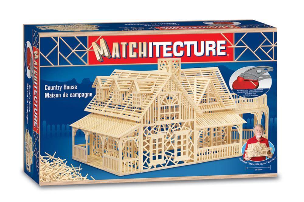 image shows a box with a large country house made of matchsticks on the front and the logo matchitecture above the house. it shows a match stick country house building kit