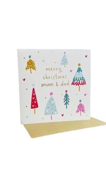 image of a greetings card with envelope with the words 'merry christmas mum & dad' inscribed. The card is illustrated with a white background and several differing styles of Christmas tree. It's a Christmas card for mum and dad.