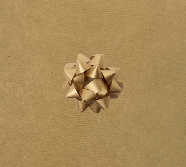 image of a square of wrapping paper, the paper is a solid natutral light brown kraft paper, in the corner of the gift wrap paper is a bright blue gift wrapping bow