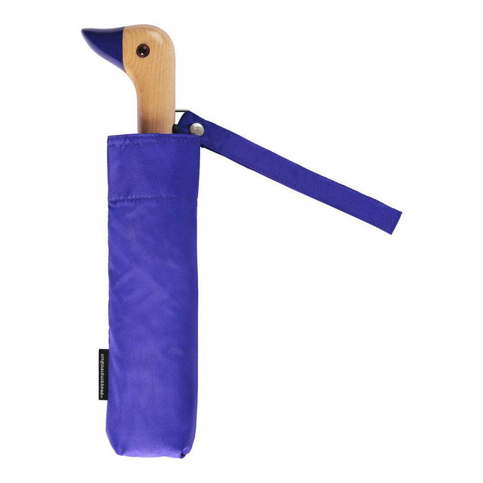 image of an umbreall whose handle is shaped like a friendly duck head, the umbrella is blue