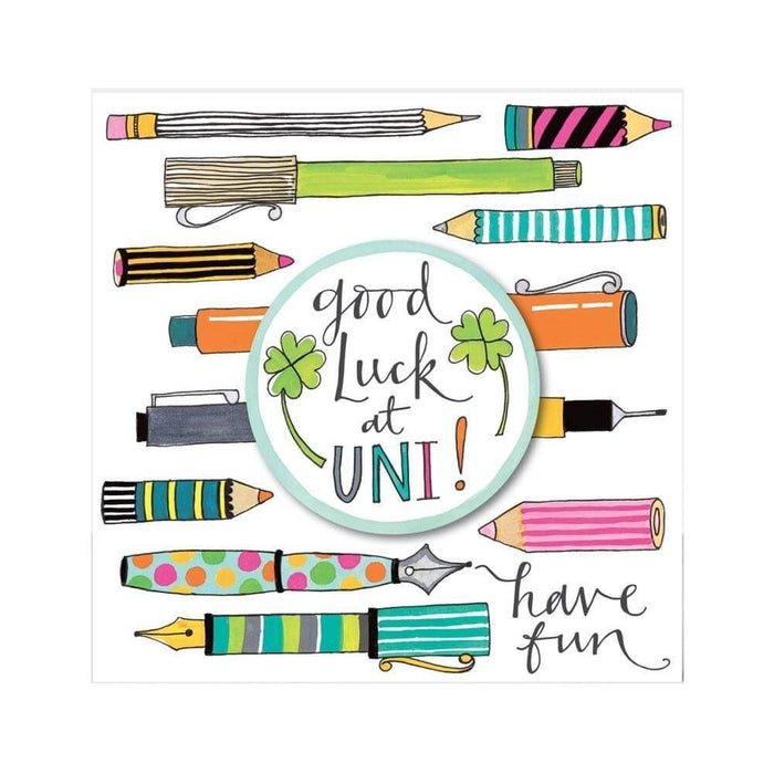 image of a greetings card with the words good luck at uni written on it. This good luck card features lots of hand drawn [pens and pencils in the backgeround and a badge on the front with two four leaf clovers amnd the words good luck at uni in the centre