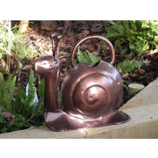 This is a hand-crafted Snail watering can which makes a great feature to your garden or home. It can be used as a watering can (indoors or out) or as an attractive ornament. It holds approximately 1.5 litres of water. It has a hammered bronze finish. Handmade in India and individually unique, these cans boast an endearing rustic charm.  Each can is 26cm high, 26cm long, 7cm wide,