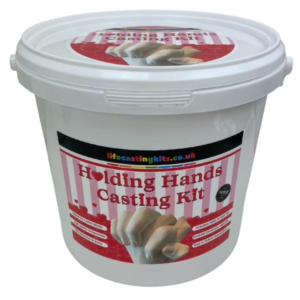 A holding hands life casting kit in a bucket style with a red, pink and white striped label design featuring lots of red love hearts and the logo lifecastingkits.co.uk at the top and holding hands casting kit underneath