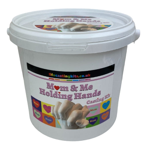 A holding hands life casting kit in a bucket style with a multicoloured label design with different checked squares featuring a heart and the word Mum on it and the logo lifecastingkits.co.uk at the top and Mum & Me holding hands casting kit underneath