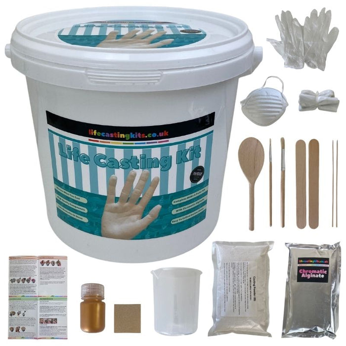 Life Casting Kit written in blue bold text on a label feature a hand cast in stone which sits on a life casting start kit bucket. Around the bucket are the contents of the casting kit, chromatic alginate, casting powder, measuring jug, paint, paint brushes, gloves, mixing spoon, stirring sticks, picks, sandpaper and instructions.