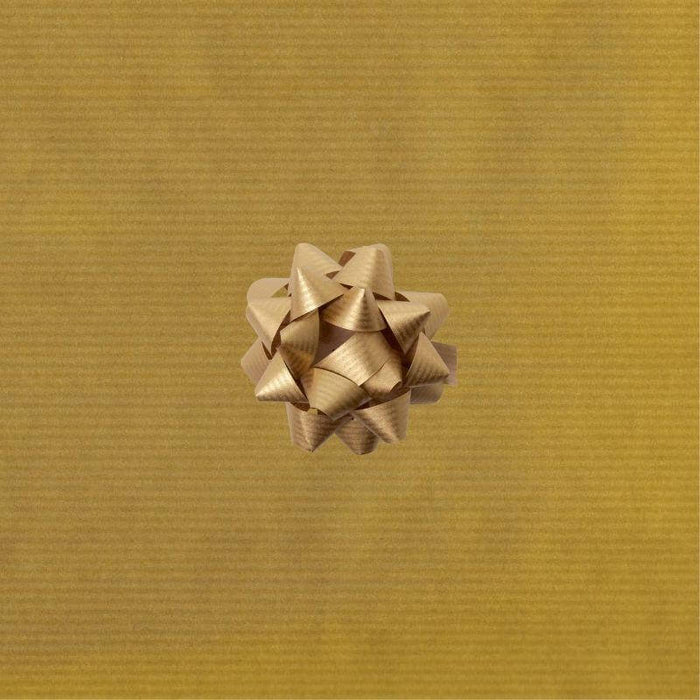 image of a square of wrapping paper, the paper is kraft paper and is a solid gold colour, in the corner of the gift wrap paper is a red gift wrapping bow