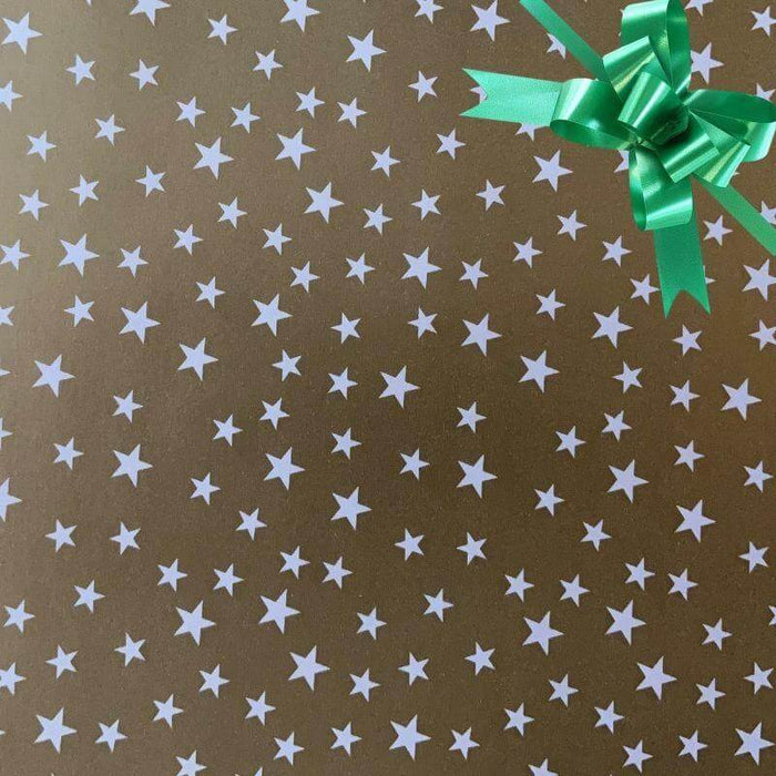 image of a square of wrapping paper, the paper is gold and features lots of solid white stars, in the centre of the gift wrap paper is a red paper gift wrapping bow