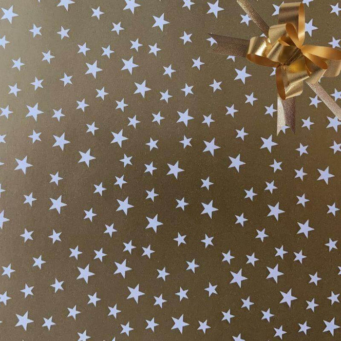 image of a square of wrapping paper, the paper is gold and features lots of solid white stars, in the corner of the gift wrap paper is a light blue gift wrapping bow