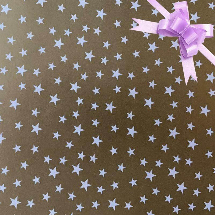 image of a square of wrapping paper, the paper is gold and features lots of solid white stars, in the corner of the gift wrap paper is a lilac gift wrapping bow