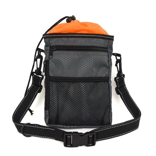image of a black rectangular shaped dog walking bag with orange lining. The bag has a black over the shoulddr carry handle and various zips, pocjkets and compartmenst to hold equipment you might need whilst walking a dog, including a pull hole for poo bags