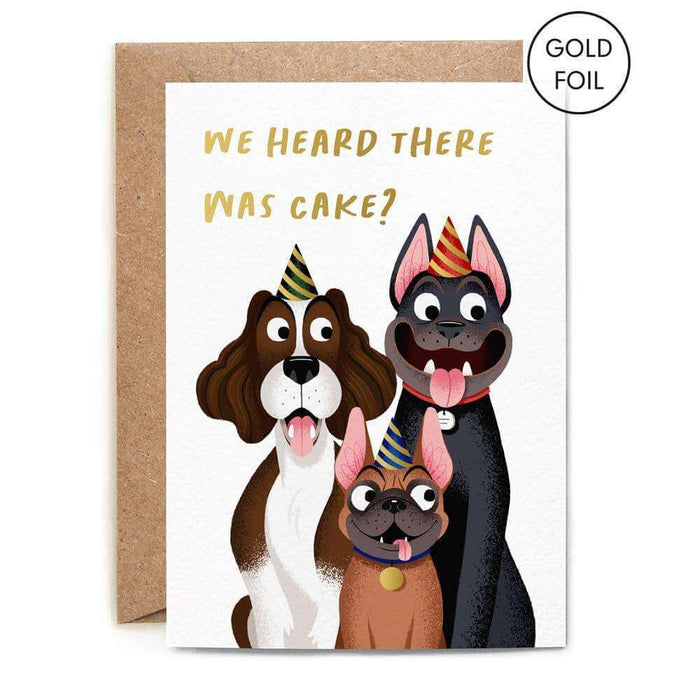  the words 'we heard there was cake?' on it and a picture of three friendly and fun looking illustrated dogs each wearing a party hat and each looking excited and expectant