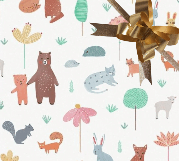 image of a square of wrapping paper, the paper has a white background with lots of child friendly illustrations of animals such as bunnies, bears and bear cubs, cats and sheeep interspered with illustrated sheep, in the corner of the gift wrap paper is a lilac gift wrapping bow