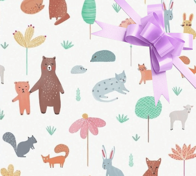 image of a square of wrapping paper, the paper has a white background with lots of child friendly illustrations of animals such as bunnies, bears and bear cubs, cats and sheeep interspered with illustrated sheep, in the corner of the gift wrap paper is a silver gift wrapping bow