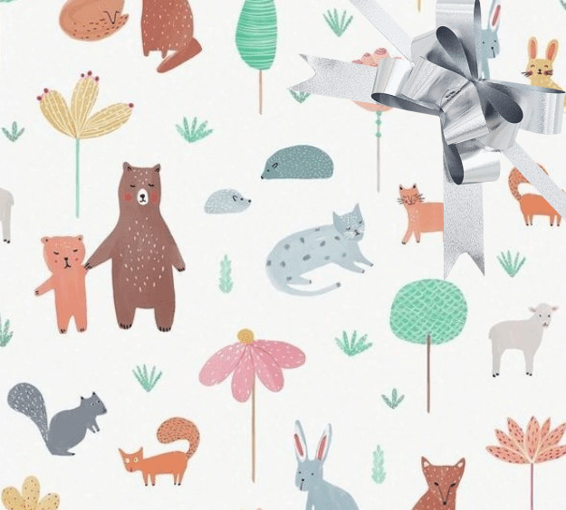 image of a square of wrapping paper, the paper has a white background with lots of child friendly illustrations of animals such as bunnies, bears and bear cubs, cats and sheeep interspered with illustrated sheep, in the centre of the gift wrap paper is a gold paper gift wrapping bow