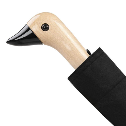 image of an umbreall whose handle is shaped like a friendly duck head, the umbrella is black