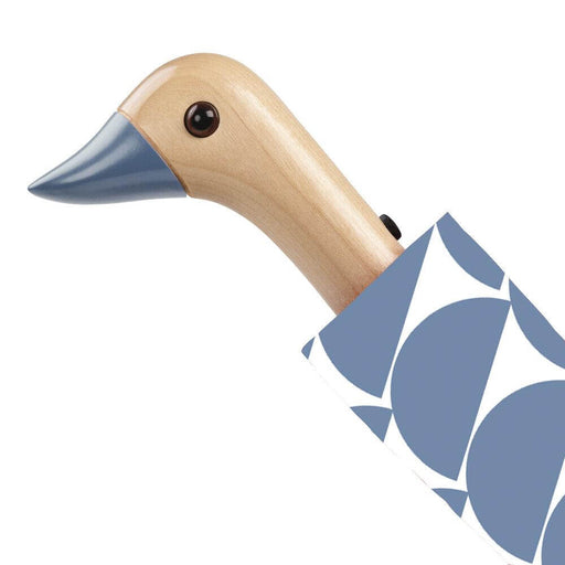 image of an umbreall whose handle is shaped like a friendly duck head, the umbrella is blue denim in colour