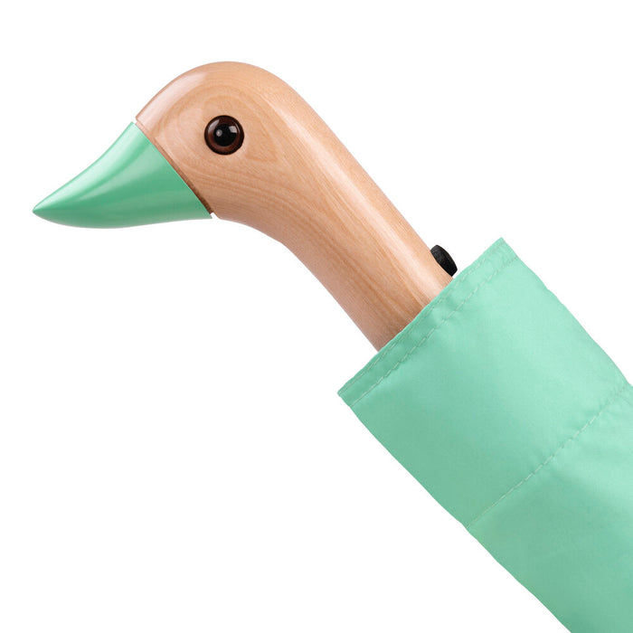 image of an umbreall whose handle is shaped like a friendly duck head, the umbrella is mint coloured