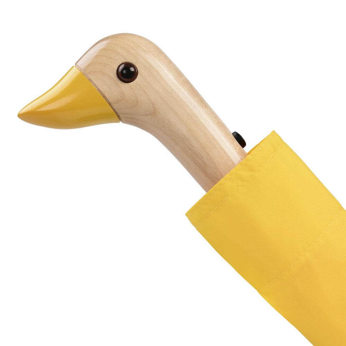image of an umbreall whose handle is shaped like a friendly duck head, the umbrella is yellow