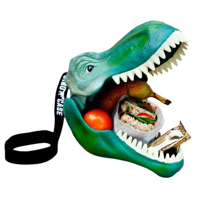 A green dinosaur head with wide open mouth, bright white teeth and the mouth is filled with sandwiches, fruit and a chocolate bar. At the back of the dinosaur head is a black carry strap to make carrying this dinosaur lunch box easy.